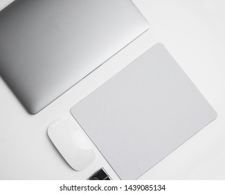 Unbraned Blank White Stationary With Laptop Mouse Mouse Pad On A White Background From Aerial View