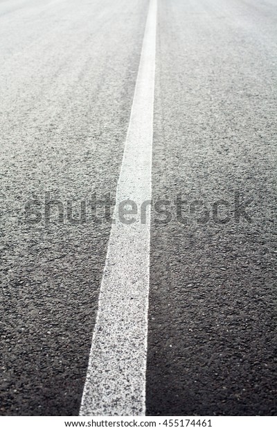 Unbroken white road\
marking line on the\
road.
