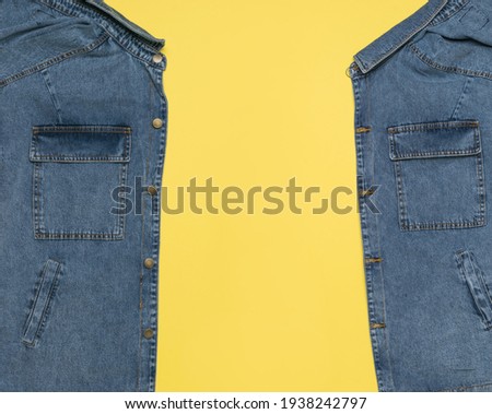 An unbuttoned blue denim jacket with a yellow background inside. Popular casual clothing. Foto d'archivio © 