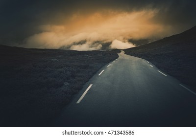 Uncertain Road Ahead. Dark And Cloudy Mountain Road Journey. Rocky Norway Landscape.