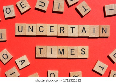Uncertain Times, words in 3d wooden alphabet letters isolated on red background, surrounded by random wood letters - Shutterstock ID 1712321512