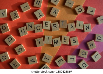 Uncertain Times, words surrounded by random alphabet letters - Shutterstock ID 1880423869