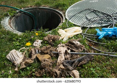 Unclogging Septic System. Cleaning And Unblocking Drain Full Of Disposable Wipes And Other Non Biodegradable Items.