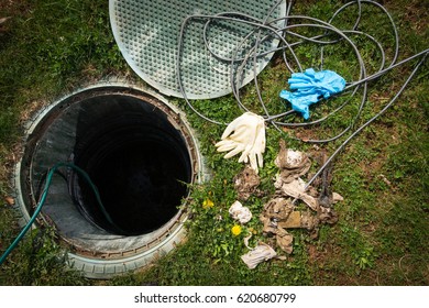 Unclogging Septic System. Cleaning And Unblocking Drain Full Of Disposable Wipes And Other Non Biodegradable Items.