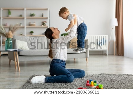 Similar – Image, Stock Photo Mother and child playing with fabric on sunny beach
