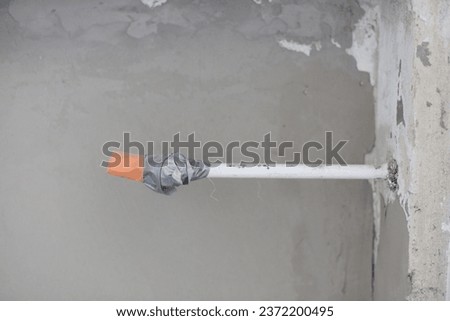 unconnected heating pipe on a wall renovation material utensils