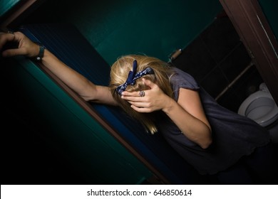 Unconscious drunk woman standing in the washroom - Powered by Shutterstock