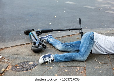 Unconscious Man Lying On Concrete Street After Accident With An Electric Scooter