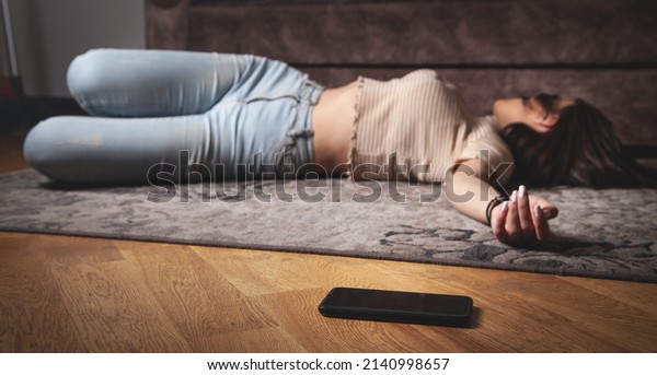 Unconscious young woman lying\
at home.