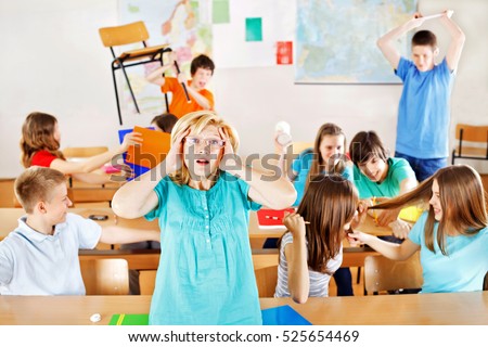 Uncontrollable pupils in classroom acting out, frustrated teacher tearing a hair out. 