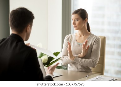 Unconvinced In Honesty Of Business Agreement Female Entrepreneur Refusing To Sign Contact With Businessman. Skeptical Young Woman Rejecting Job Offer When Sitting At Desk In Front Of Hiring Manager