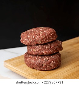 uncooked burger patty hamburger black   - Shutterstock ID 2279857731