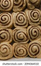 Uncooked Cinnamon Roll Buns Ready To Bake. Baking Food. Breakfast Pastry. Cinnamon Buns. Spices, Sugar. Holiday Winter Comfort Food. Festive Food. Closeup Flat Lay. Baking Tray. Oven Ready. Uncooked