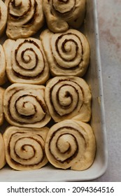 Uncooked Cinnamon Roll Buns Ready To Bake. Baking Food. Breakfast Pastry. Cinnamon Buns. Spices, Sugar. Holiday Winter Comfort Food. Festive Food. Closeup Flat Lay. Baking Tray. Oven Ready. Uncooked