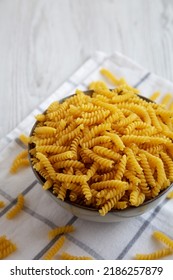 Uncooked Dry Girandole Torsades Pasta In A Bowl, Side View. 