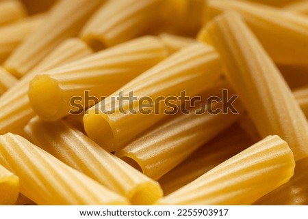 Uncooked dry pasta. Food background. Close up of noodles.