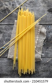 Uncooked Dry Spaghetti On Wooden Surface.From Above