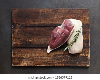 Uncooked Duck Breast With Herbs And Spices On A Dark Wooden Cutting Board. Overhead View. Copy Space