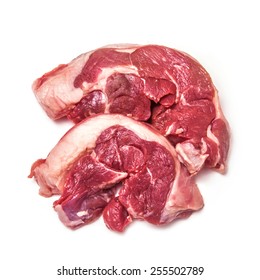 Uncooked Goat Meat Leg Steaks Isolated On A White Studio Background.