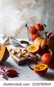 Uncooked homemade pumpkin gnocchi on wooden board. - Shutterstock ID 2210783969