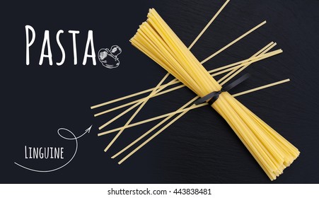 Uncooked Italian Pasta Linguine On Black Slate Stone Background With White Lettering, Top View