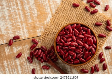 Uncooked Kidney bean or Red beans in wooden teak bowl with copy space.Top view.