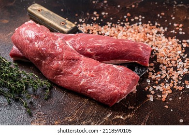 Uncooked Lamb Loin Fillet, Mutton Raw Meat On Butcher Cleaver. Dark Background. Top View