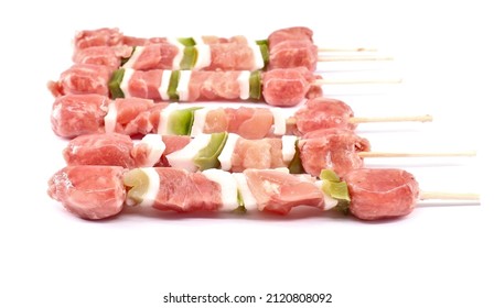 Uncooked mixed meat skewer with peppers, ready to be grilled.  White background - Powered by Shutterstock