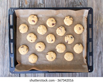 Uncooked oatmeal cookies on baking paper on a baking sheet - Powered by Shutterstock