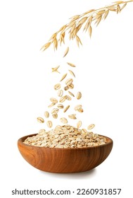 uncooked oatmeal falling from ripe oat ears in wooden bowl isolated on white background - Shutterstock ID 2260931857