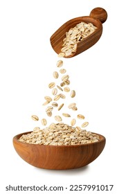 uncooked oatmeal falling from scoop in wooden bowl isolated on white background - Shutterstock ID 2257991017