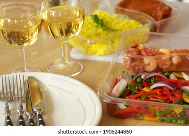 Uncooked Pre Prepared Meal With Fresh Prawns, Chorizo, Peppers, Red Onion And Rice, Arranged With White Wine, Plates And Cutlery