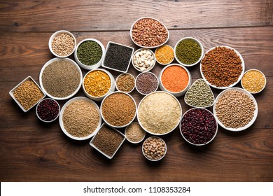 Uncooked pulses,grains and seeds in White bowls over wooden background. selective focus
 - Shutterstock ID 1108353284