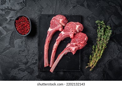 Uncooked Raw Lamb chop steak, mutton cutlet on marble board. Black background. Top view. - Powered by Shutterstock