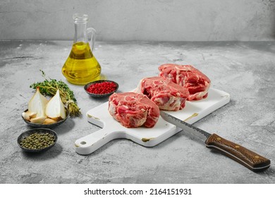 Uncooked Raw Lamb Loin Chops Saddle Steaks On Wooden Cutting Board