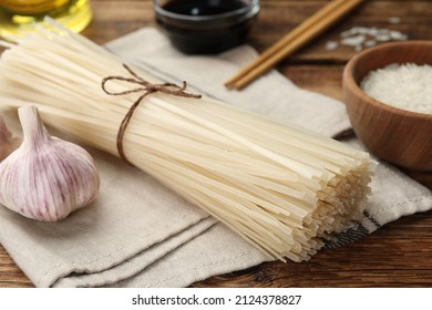 Uncooked Rice Noodles On Wooden Table, Closeup