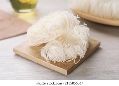 Uncooked Rice Noodles On Wooden Table, Closeup