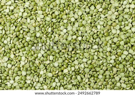 Uncooked, split, green peas background. Dry peas grains. Top view