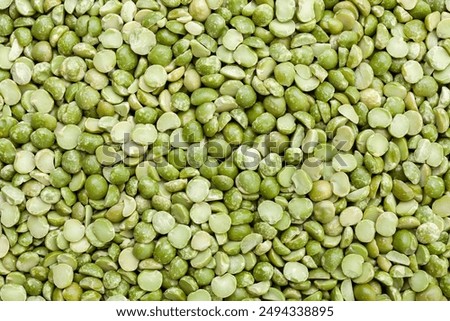 Uncooked, split, green peas background. Dry peas grains. Top view
