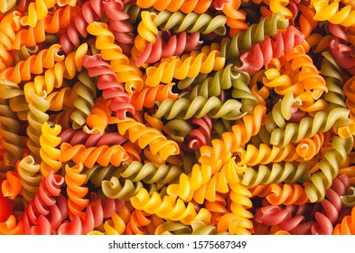 Uncooked tricolore fusilli pasta twist shapes background. Stock photo pasta twist shapes. - Powered by Shutterstock