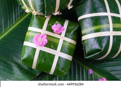 Uncooked Vietnamese Chung Cake isolated. It's a square glutinous sticky rice cake, stuffed with pork meat, green beans and wrapped in bamboo leaf. Traditional Vietnamese New Year (Tet) food.