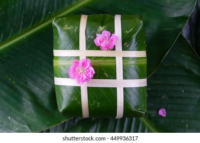 Uncooked Vietnamese Chung Cake isolated. It's a square glutinous sticky rice cake, stuffed with pork meat, green beans and wrapped in bamboo leaf. Traditional Vietnamese New Year (Tet) food.