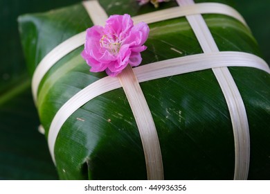 Uncooked Vietnamese Chung Cake isolated. It's a square glutinous sticky rice cake, stuffed with pork meat, green beans and wrapped in bamboo leaf. Traditional Vietnamese New Year (Tet) food.