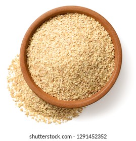 uncooked wheat germ in the wooden bowl, isolated on the white background, top view