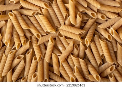 Uncooked whole grain pasta. The raw penne pasta. Top view.