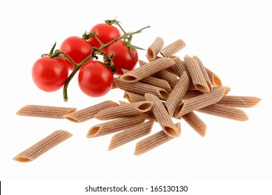 Uncooked Whole Wheat Pasta With Tomato Isolated On A White Background