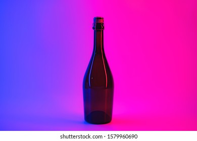 Uncorked bottle of sparkling wine in neon background. Alcoholic beverage in vibrant lights, the concept of partying, holidays and drinking - Powered by Shutterstock