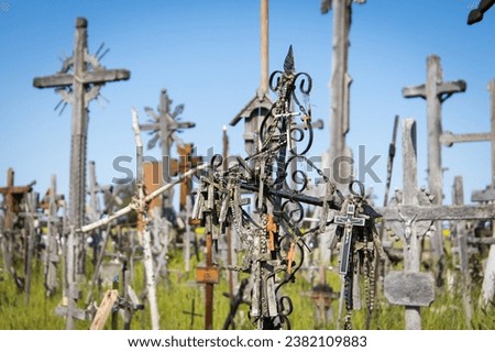 Uncountable crosses and cruzifixes at the Hill of Crosses in Lithuania as part of a pilgrimage destination and tourist attraction