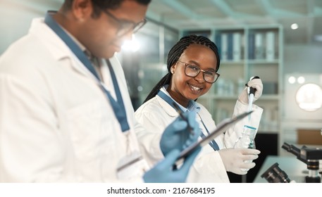 Uncovering Something New. Portrait Of A Young Scientist Working Alongside A Colleague In A Lab.