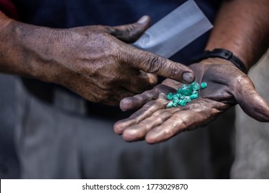 Uncut emeralds in the hand of a Colombian emerald miner in Muzo, Colombia.  - Shutterstock ID 1773029870